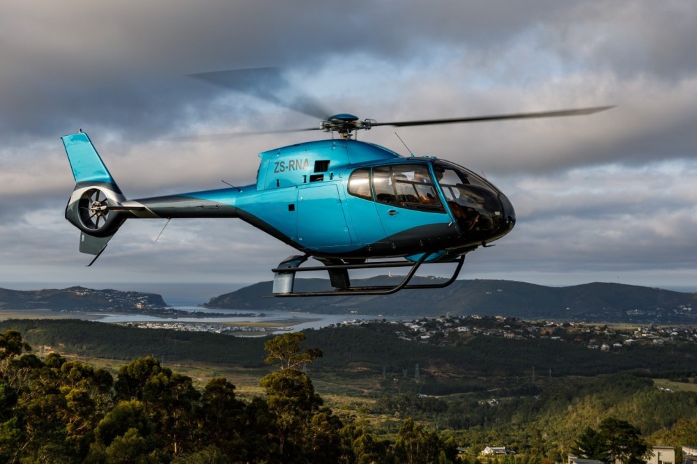 Duran De Villiers about land his incredible EUROCOPTER EC 120 against the breathtaking backdrop of the Knysna Heads at the renowned Simola Hotel helipad.