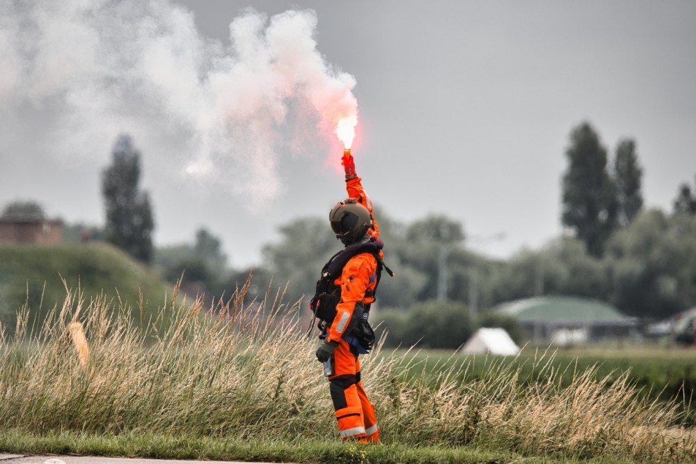 Crew Member lights a flare to draw attention to itself. A short time later, he was "saved" using a helicopter. The Belgian Air Force performed this as part of an exercise.