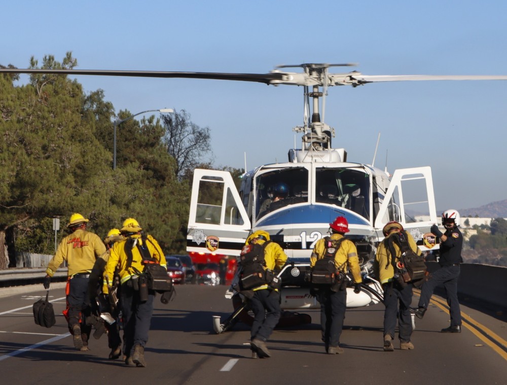 Gillespie Helitack crew from CAL FIRE San Diego, returning to their helicopter at the tail end of the small Scripps Fire in Poway, CA. During a wildfire, the crew is strategically inserted as an initial attack platform.