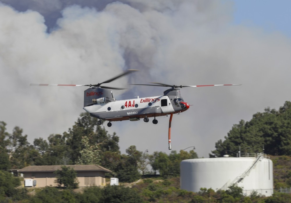 Billings Helitanker 8AJ, approaches a reservoir dip site during the massive Airport Fire, that sparked in the Trabuco Canyon area of Orange County, CA.