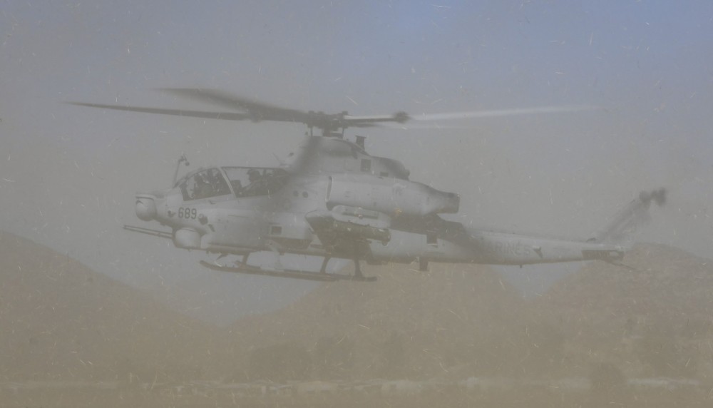 An AH-1Z Viper from Marine Light Attack Helicopter Training Squadron 303 (HMLAT-303) "Atlas", kicks up a dust storm during hovering maneuver, following a fly-in event in Riverside County (CA).