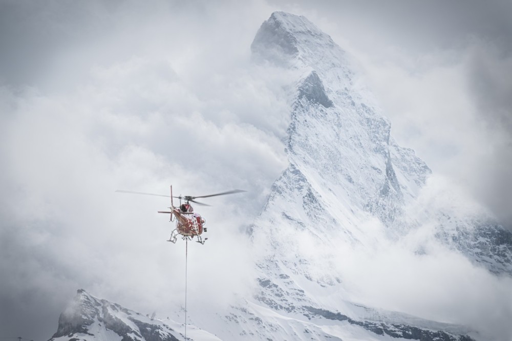 Air Zermatt HB-ZOY - Helicopter External Sling Load (HESLO) in the municipality of Zermatt. 
Helicopter sling load operations in a village require careful planning, skilled crews, and a focus on safety and precision to successfully carry out tasks in an urban setting.