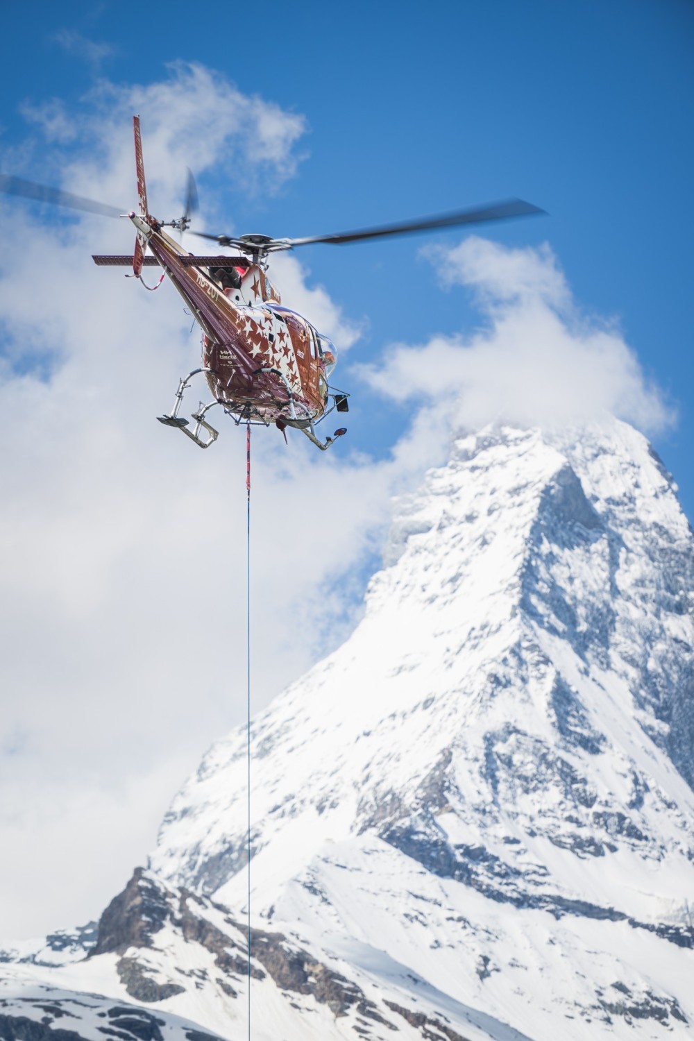 Air Zermatt HB-ZOY - Helicopter External Sling Load (HESLO) in the municipality of Zermatt. 
Helicopter sling load operations in a village require careful planning, skilled crews, and a focus on safety and precision to successfully carry out tasks in an urban setting.