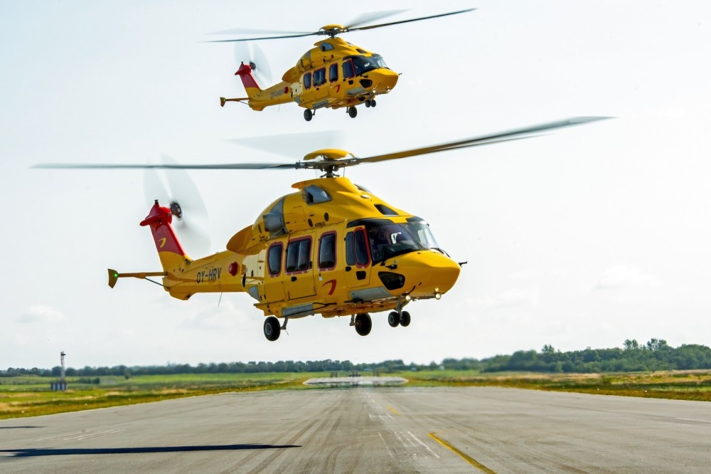 Two H175s from the NHV hover above the runway at Esbjerg Airport in Denmark. These helicopters fly daily to other oil and gas platforms in the North Sea.