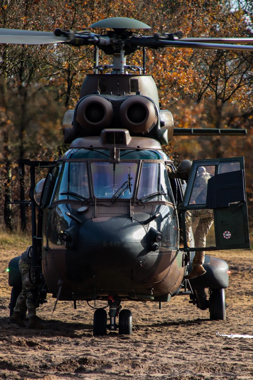 Pilots getting in to the Cougar after a short brake while waiting for another Cougar helicopter to be refueled. After this they switch places and they can also be refueled.