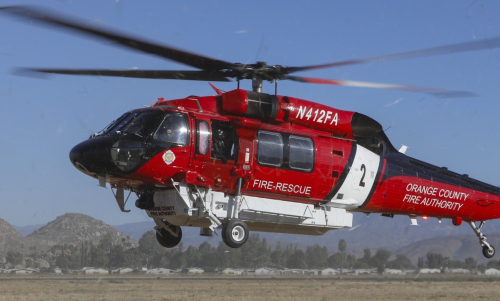 A close-up with the Sikorsky S-70M from Orange County Fire Authority, as they kick up dust and debris upon arriving at the annual Riverside County Sheriff Aviation Fly-in, in Riverside County (CA).