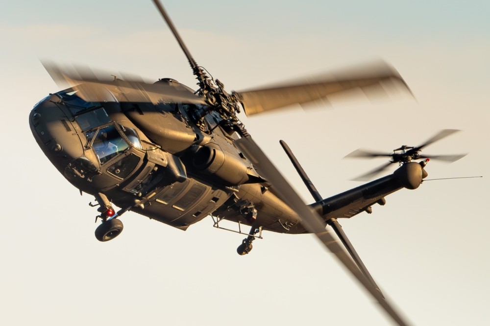 A Sikorsky UH-60 Black Hawk military helicopter from the 2nd Helicopter Squadron (Malmen Air Base) of the Swedish Air Force during a beautiful sunset.