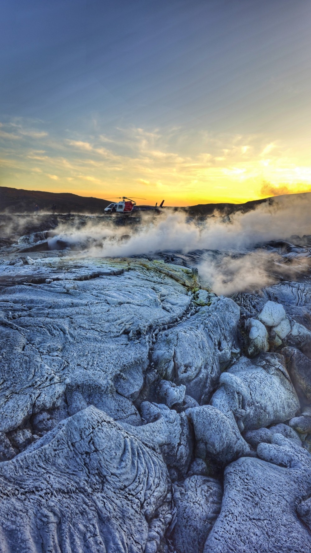 Golden Hour Adventures in Iceland
Today was an absolutely stunning day for helicopter tours! I had the privilege of flying twice to the glacier and then to the eruption area.

At the glacier, winter truly made its presence felt with a chilling -16°C, but the eruption zone brought a surprising warmth by comparison. I even made a landing near one of the older eruption sites, and let me tell you, the view was nothing short of magical. The sunset bathed the steam rising from the lava fields in a golden glow—it felt like stepping into another world.

We’re now entering what I consider the best season in Iceland: the golden hour months. From our first flights around 11 a.m. to sunset at 3:30 p.m., the soft, golden light transforms every landscape into a masterpiece.