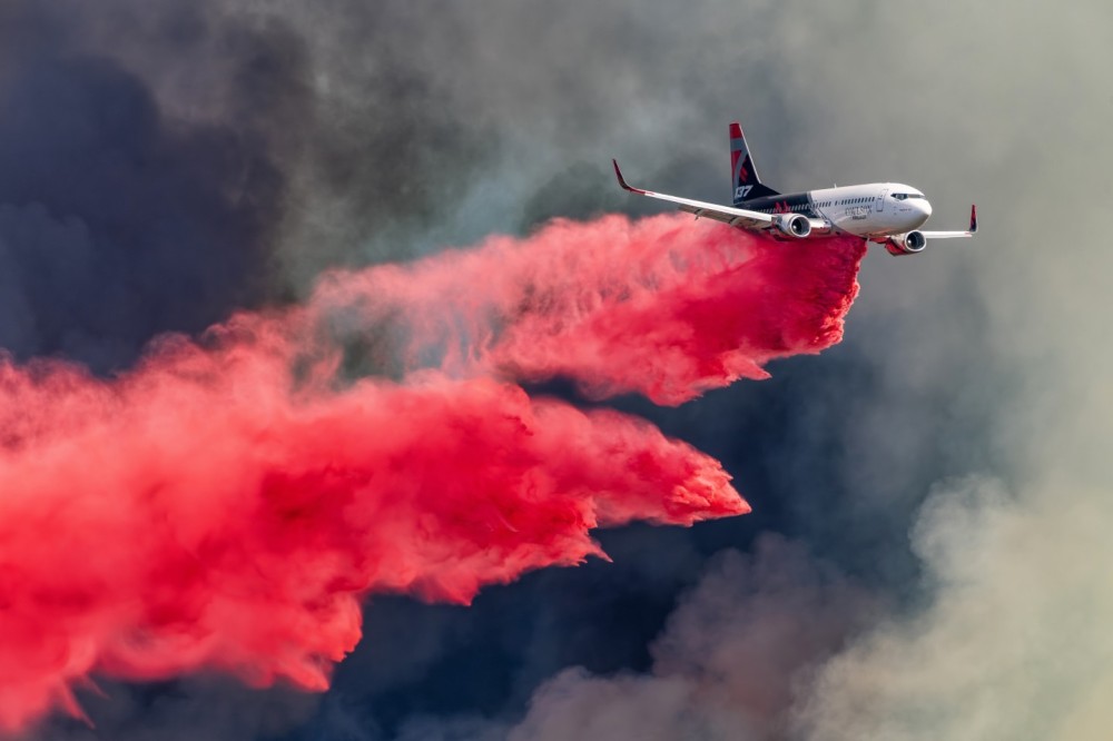 The smoke clouds produced at the Nixon Fire in Anza, California were massive because the fire had a lot fuel.  Getting to the right location was very difficult because my son and I had to navigate around many rough, dirt roads.  As Coulson’s Boeing 737 came in to make a drop, the light illuminated it perfectly, and the background really made for a dramatic photograph.