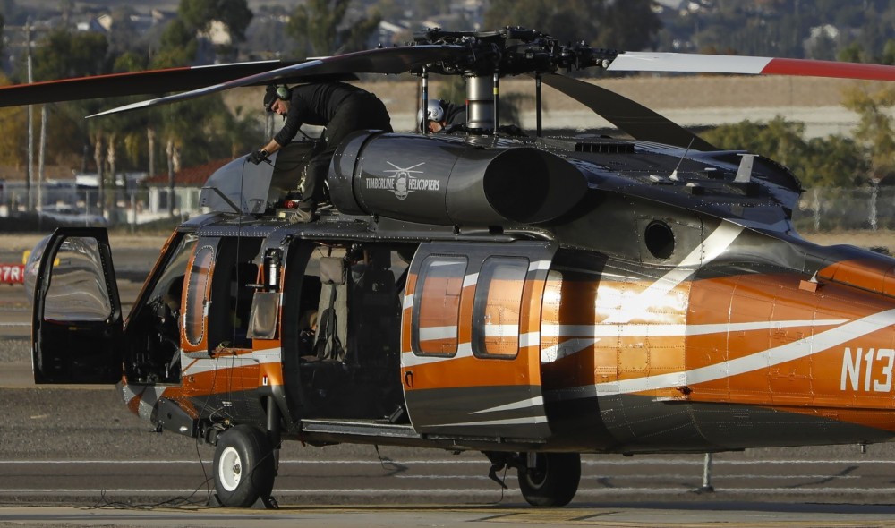 A Timberline Helicopters S-70 Black Hawk undergoes engine maintenance with the aircraft's auxiliary power unit, on the ramp of Gillespie Field in El Cajon, CA following a lengthy fire season in California.