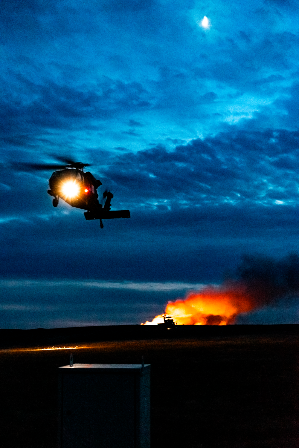 UH-60M assigned to A co 3-1 AHB returns from successful night iteration of aviation gunnery.  Visible in the background, the mark they were there, a massive range fire.