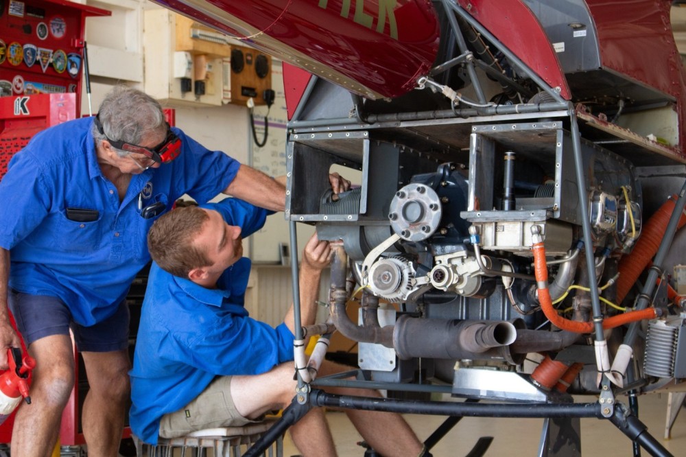 Helimuster NT was started in 1976 at Victoria River Downs Station in the Northern Territory of Australia. It now operates over 40 machines across the state including cattle mustering, aerial fire fighting and various charter services. Pictured is Ron (left) who started his engineering career with Qantas in 1964, teaching our apprentice James a thing or two about the Robinson R22 helicopter used for mustering cattle.