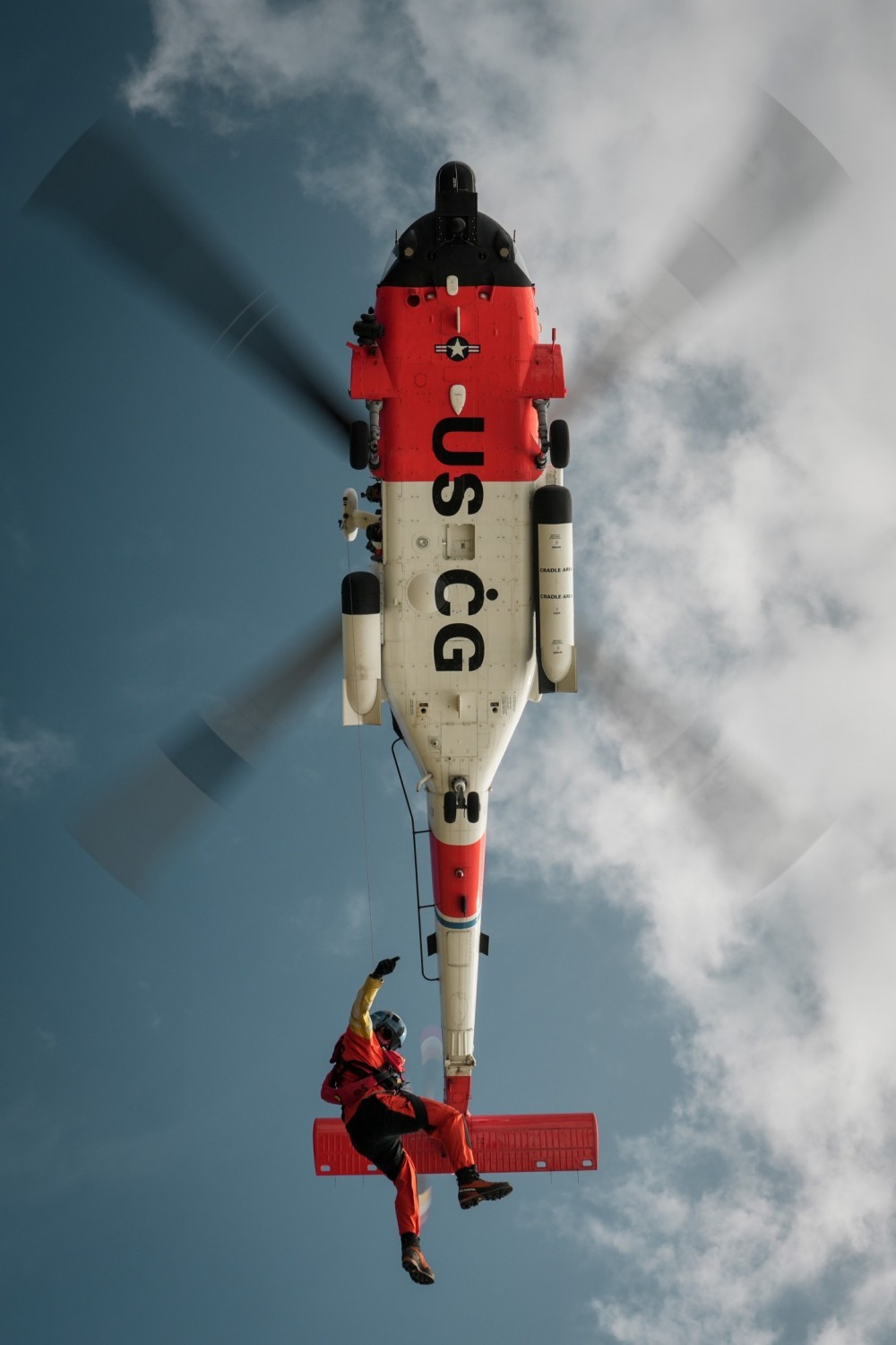 A Coast Guard Rescue Swimmer is lowered from a MH-60T during a training exercise at the Advanced Helicopter Rescue School in Astoria, OR.