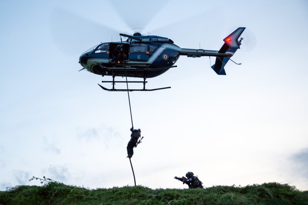 In June 2024, I photographed GIGN Special Forces during a fast roping exercise from a FAGN EC145 helicopter. In the photo, one GIGN operator is fast roping down, while another secures the area from the ground.