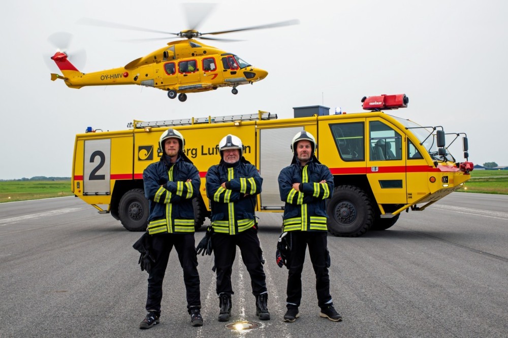 During my visit to the NHV at Esbjerg Airport, I photographed the Airbus H175 helicopter alongside the fire truck and the fire brigade personnel on the runway.