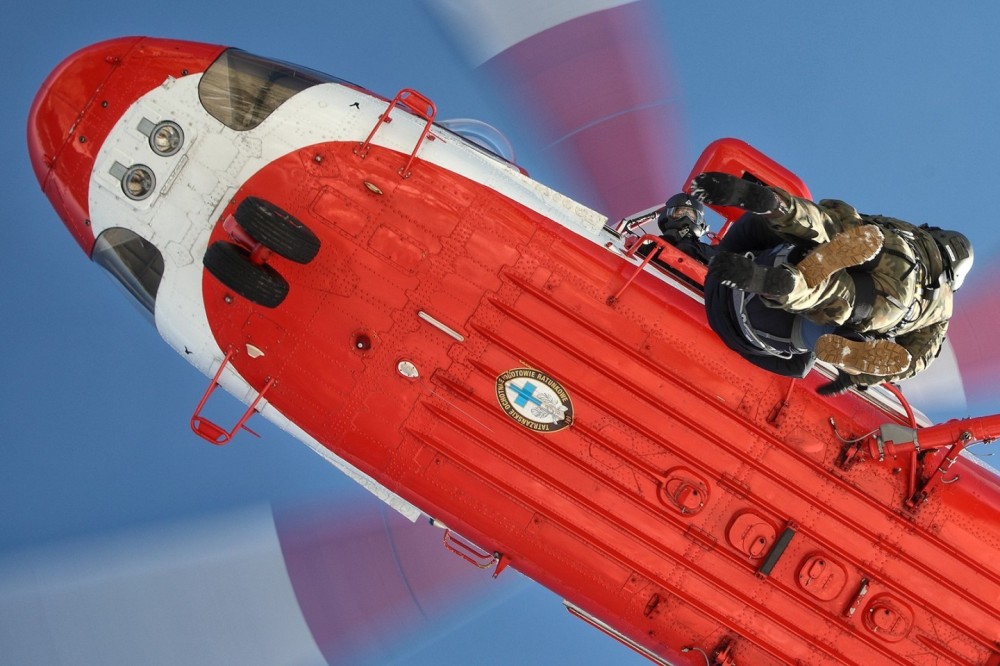 Tatra Mountain Rescue Service member during hoist operation with military personnel