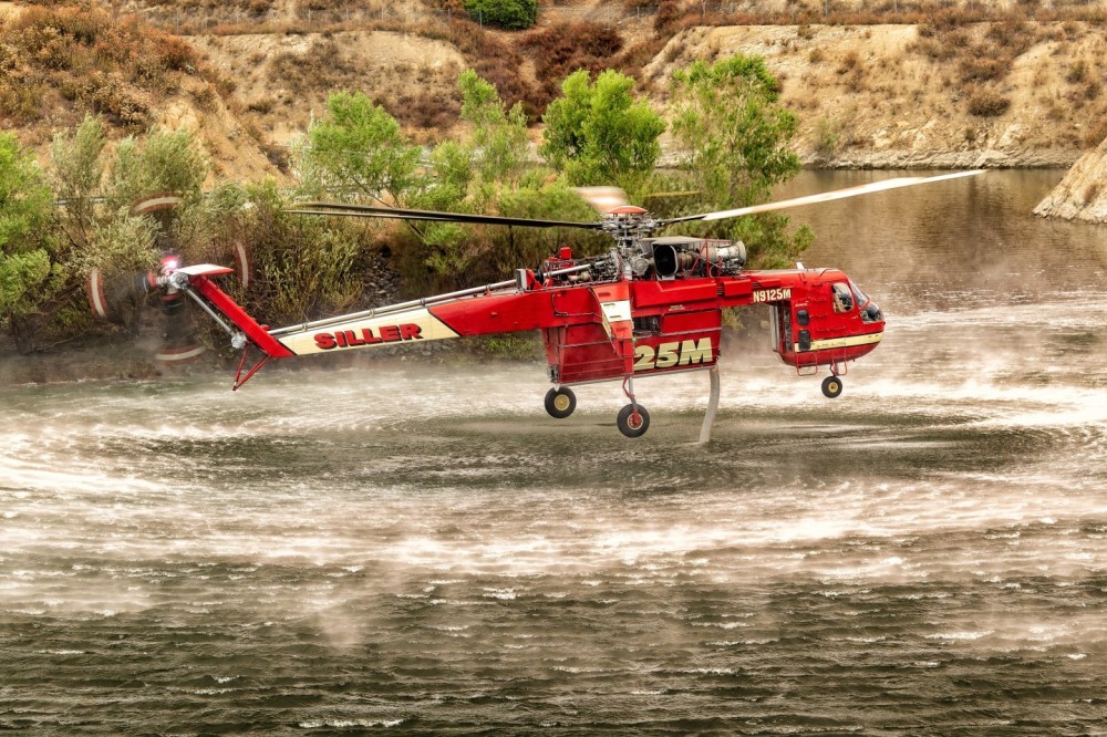 Siller's Skycrane gets water at Crafton Hills Reservoir for the Line Fire in the San Bernardino Mountains.  The sky was covered in smoke clouds, which produced warm, soft light.  I had to walk about a half mile to get to this location.