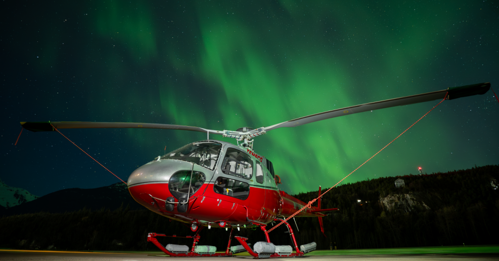 After a long day of training new pilots for the upcoming season, this ASTAR rests while the lights dance above it in Skagway, AK.