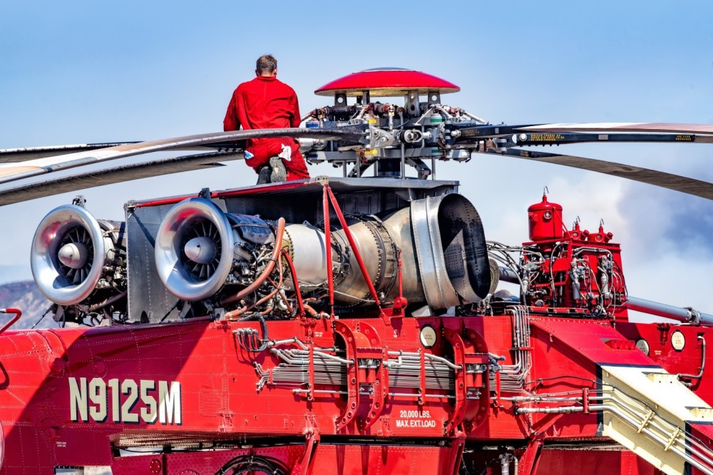 A mechanic, from Siller, checks out their Skycrane at Redland Municipal Airport after it came back from dropping on the Line Fire in the San Bernardino Mountains. I got permission to photograph on the flight line at the airport.