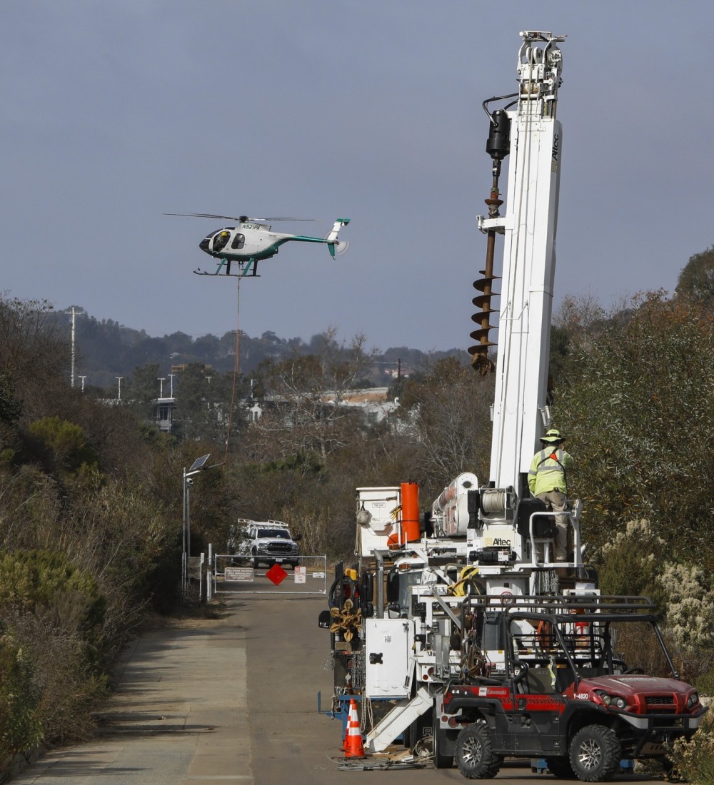 A McDonald Douglas 500 (MD 500) operated by English Air Services returns to the starting point during a construction project in the Torrey Pines area of San Diego, CA.