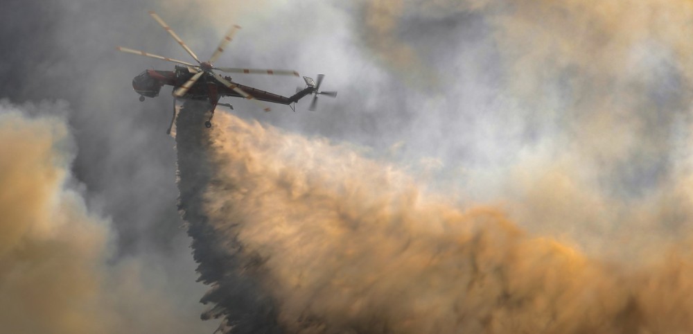 A rapidly spreading wildfire near Campo, CA sparks a multi-agency wildland response to extinguish the Posta 3 Fire from growing past 450-acres, as a Sikorsky S-64 Skycrane helicopter from the San Diego Gas & Electric, based at Gillespie Field in El Cajon, CA.