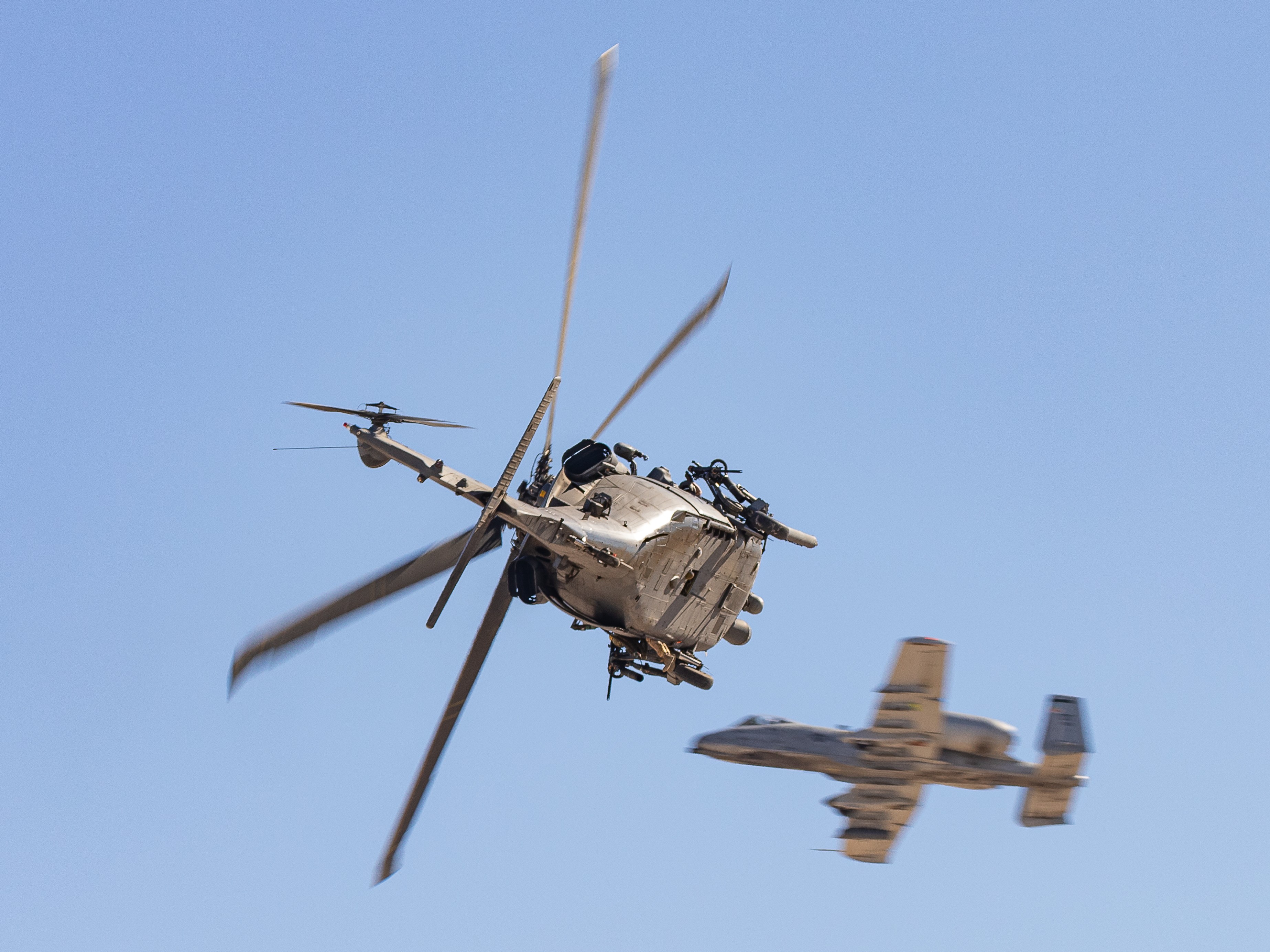 US Air Force A-10C Thunderbolt II providing air cover for a US Air Force HH-60G Pave Hawk helicopter during the combined arms demonstration at the 2022 Aviation Nation Airshow at Nellis AFB, Nevada, USA