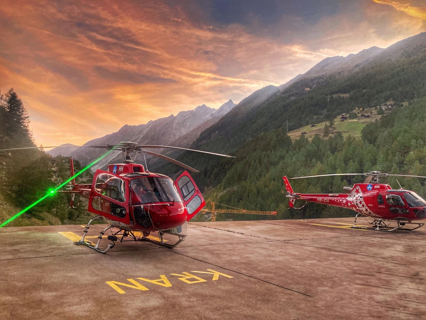 two airbushelicopters h125 are ready in a wonferful sunrise morning to do some arial work in the region of zermatt next to rhe famous mountain the matterhorn