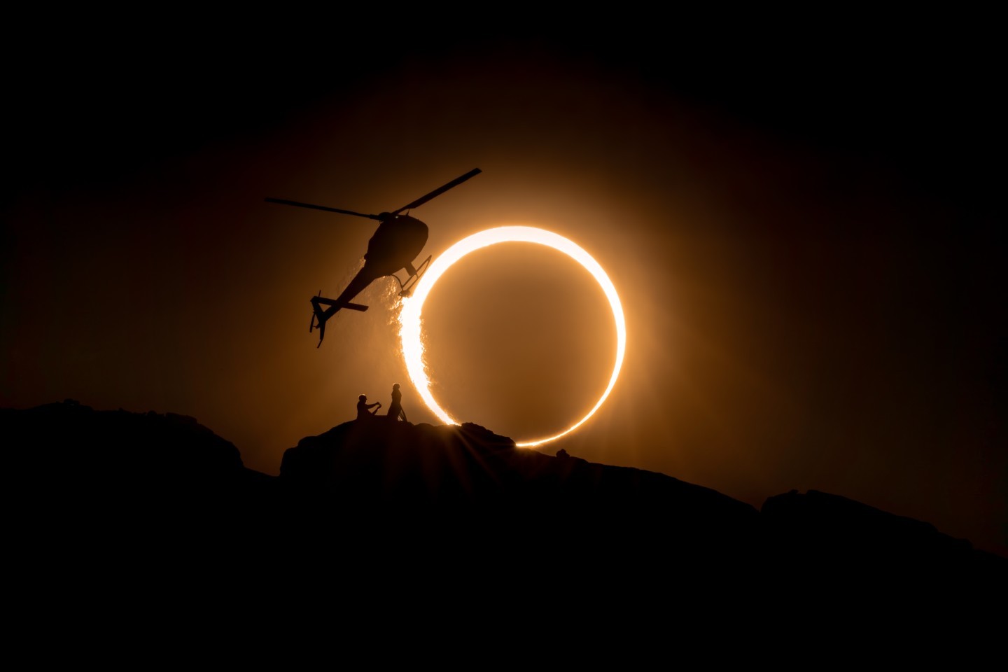 Dreams coming true as helicopter pilot Jeff Mullen proposes to fixed wing pilot Bethaney Lewis in front of October's annular solar eclipse. After dropping them off, Joe Metzger watches in Voodoo Air's Astar from a half mile away.