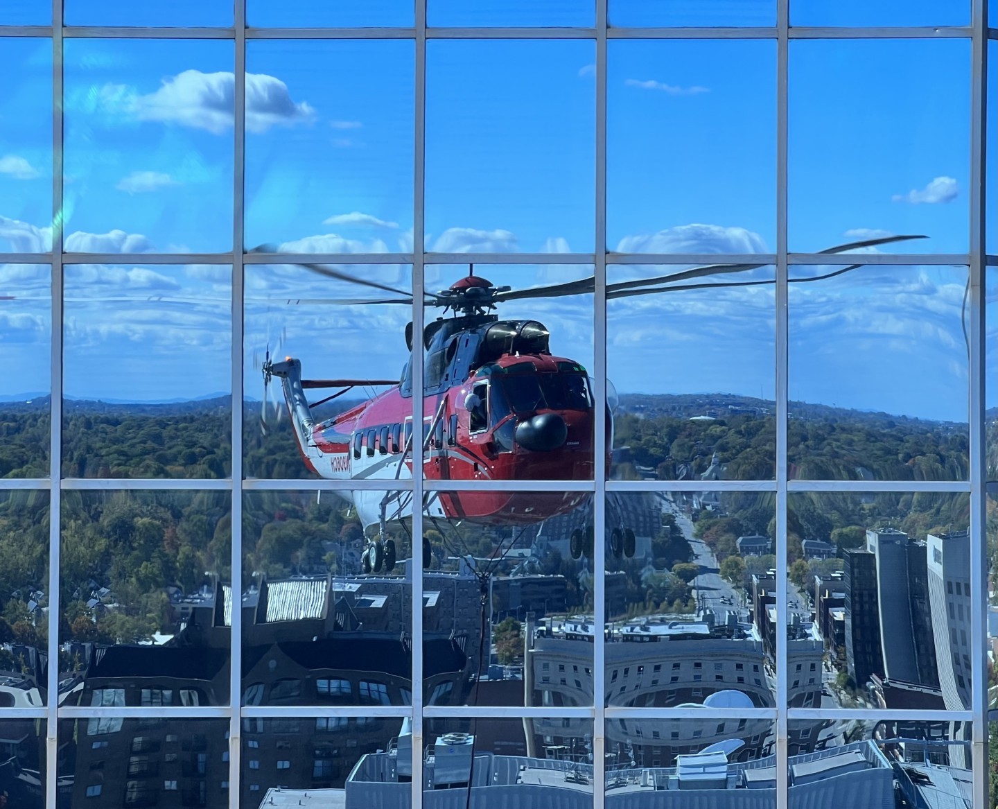 A CHI Inc S-61 reflects off the 5/3 financial center windows while changing out the sign on the 31st floor. The two signs were removed and replaced in halves plus the new canvas for a total of 5 lifts.