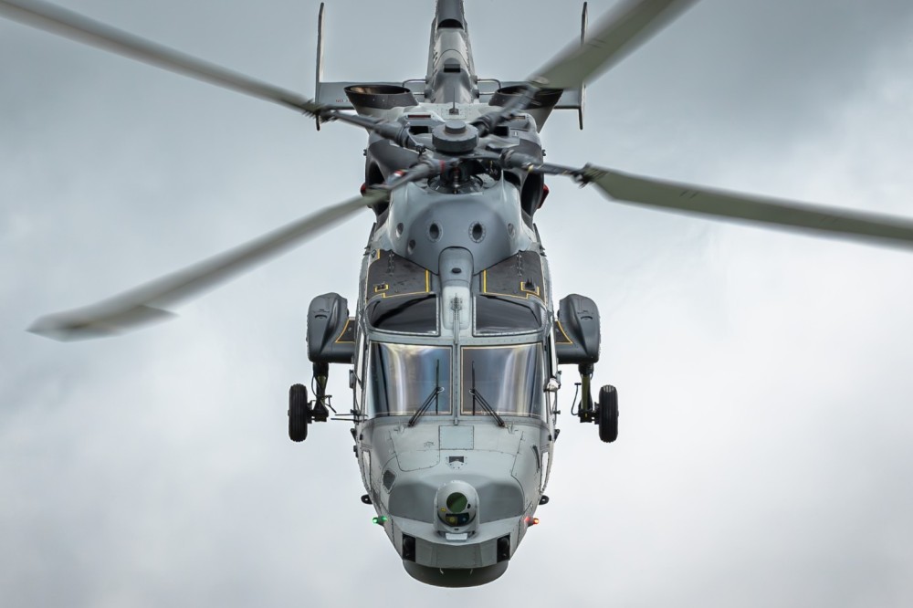 An AgustaWestland AW159 Wildcat military helicopter of the British Royal Navy is performing a demonstration during the RIAT 2024 airshow at RAF Fairford.