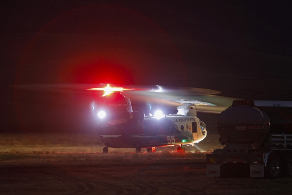 This heavily modified CH-47D Chinook operated by Coulson Aviation and part of their Quick Reaction Force (QRF), operates as Helitanker 55, during nighttime fire operations on a raging vegetation fire south of Tehachapi, CA.