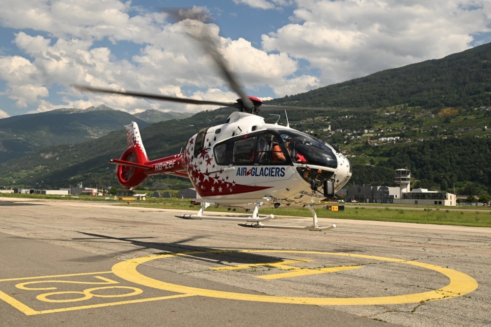 1st test flight with its new Ai-Glaciers color for the first of the H135 T3s the Hotel Bravo Zoulou Echo Fox in front of the maintenance workshops 15.07.24