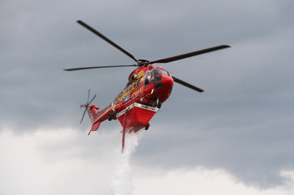 Australian Helitak FT4250 at work dumping its 4250L water load from a AS332 Super Puma from European Firecats (HeliAustria/LionsAir) during a live demo at Bad Voslau airport.