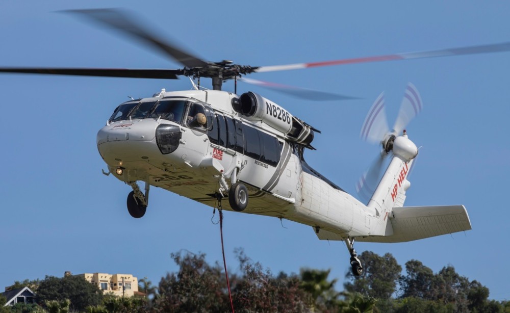 Sikorsky HP-60A Black Hawk helicopter operated by High Performance Helicopters based in La Verne, CA, conducts a pole setting flight operation in a rural part of San Diego County called Harbison Canyon, CA.