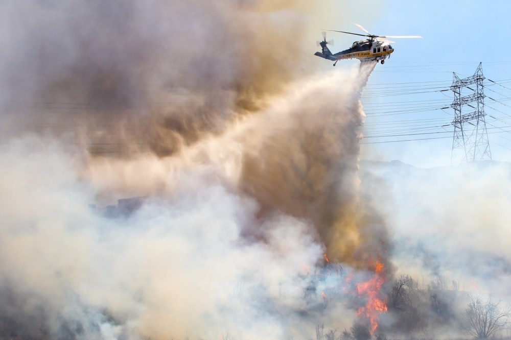 Los Angeles County FD Copter 22 makes a drop on the Placerita Fire in Santa Clarita on September 4, 2024.  This was one of three fires along State Route 14.  In total, around 10 acres burned thanks to the good work of helicopters and hand crews.  Among the hazards was a set of high tension power lines on a nearby hillside.