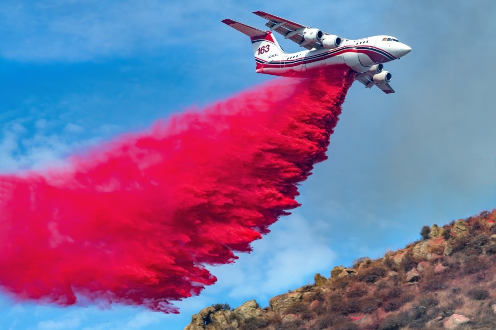 Many times when you go to a fire, there is normally only one side you can photograph from for a variety of reason. When you get to the correct location to capture a drop and the light is perfect, the retardant and aircraft are very vivid and clear. In this photograph, AeroFlite’s BAe Avro RJ85, drops Phos-Chek on the Columbia Fire in Riverside, California.