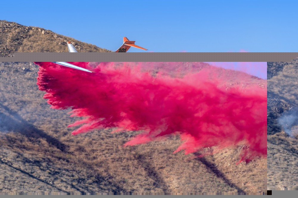 Erickson Aero Tanker’s MD-87 drops on the Sierra Fire in Jurupa Valley, California. I was shooting helicopters picking up water at the Oak Creek Golf Course. Usually, you can only get helicopters picking up water, or aircraft dropping retardant. This location was perfect for capturing both. There were houses on the bottom of the mountain so they were laying retardant down to prevent the fire from moving in that direction. The smoke on the far left adds an interesting visual element and helps tell the story.