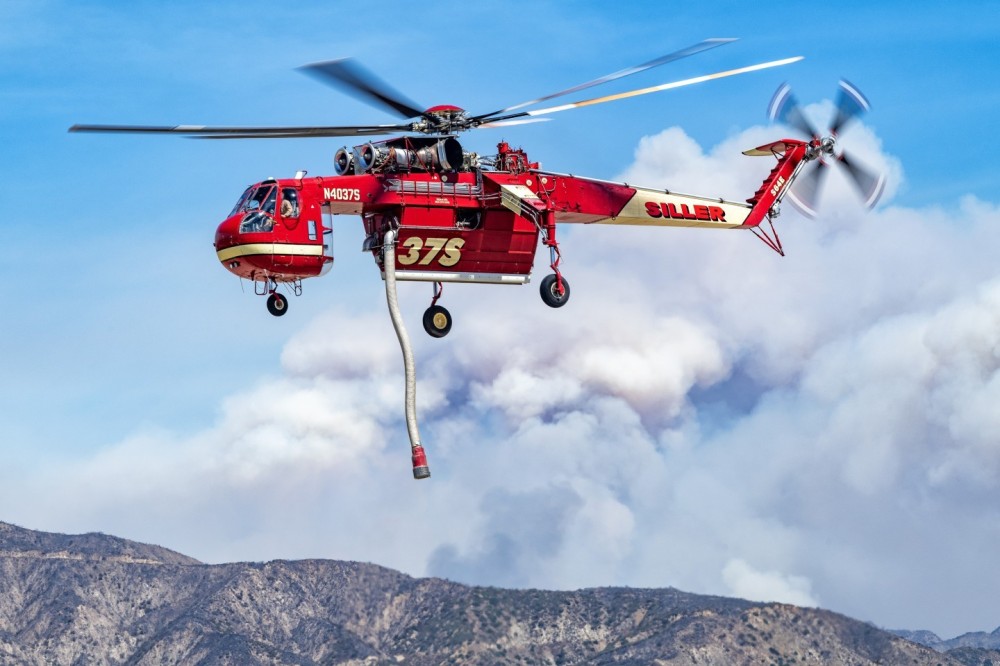 I saw that a few of the helicopters fighting the Line Fire in Highland, California were based at Redlands Municipal Airport.  I got permission to go out on the flightline and did a variety of pictures. When Siller’s Skycrane took off to drop on the Line Fire, I positioned myself so I could get the smoke from the fire in the background. Being so close to these beautiful and powerful helicopters, is an awesome experience. This picture was taken at 145mm.