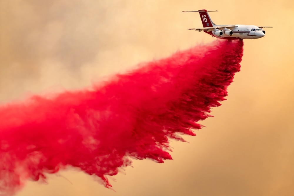 Neptune’s BAe-146 does a drop at the Nixon fire in Anza, California with a massive smoke cloud behind it. In order to get to this location, my son and I had to drive on numerous rough, dirt roads and at the same time, keeping out of the way of all the firetrucks.  On big fires like this one, it is so difficult to get to the right location to get aircraft dropping and maintaining a safe distance from the fire.  Throughout the day, we drove on many dirt roads.