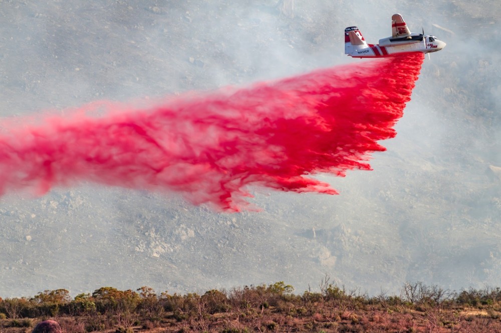 We had to drive up a steep dirt road to get a view of the valley below where the Nixon Fire was. Cal Fire’s S-2 came  in dropping retardant and because we were on a small mountain, we got an excellent view of the valley below and the smoky mountain background.