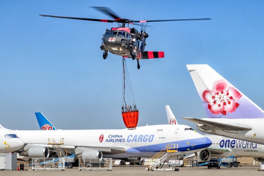 I photograph this Air National Guard Blackhawk coming into Southern California Logistic Airport in Victorville, California after fighting the Bridge Fire in Angeles National Forest. The flight line has commercial aircraft from all over the world being stored and used for spare parts.  I like the relationship between all these aircraft and the Blackhawk landing above them.  It makes for a compelling photograph.