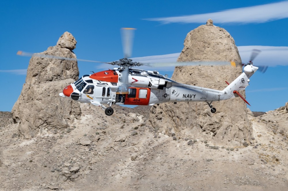 Naval Air Weapons Station China Lake Search and Rescue MH-60S Blackhawk practices out in the Southern California desert. A crew member can be seen in the door with the blurred blade in front of him as the Blackhawk does a low and fast turn.