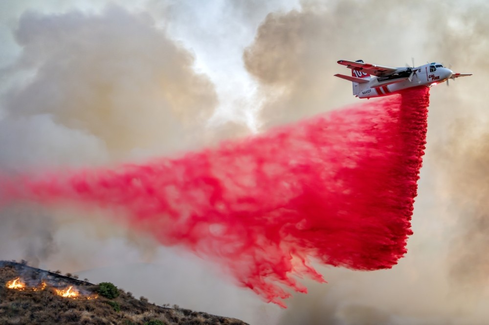 The sun had gone down behind a mountain when Cal Fire's S-2 did one of its last drops of the day at the Jake Fire in Beaumont, California. I opened my lens to f/2.8 so I could get a high enough shutter speed to get the aircraft sharp. I had to drive on a mountain dirt road, with sections of the fire burning in the valley below. Multiple times I had to move my car because the fire was coming close and to prevent the retardant from falling on my car.