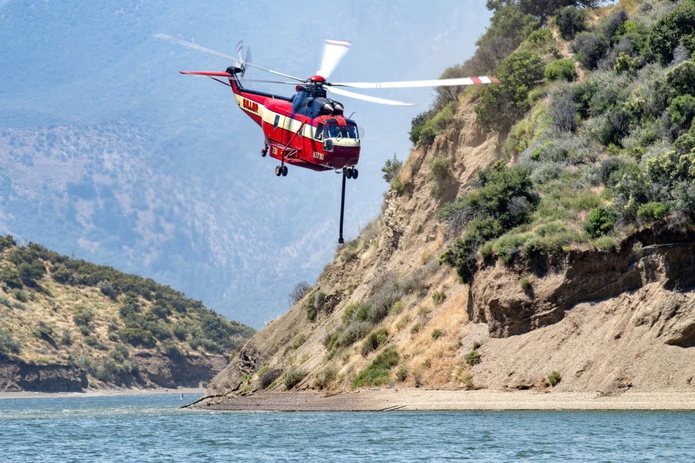 I went to Pyramid Lake near Castaic, California to get Siller's Sikorsky SR-61A picking up water to drop on the Post Fire near Gorman, California.  I had to get permission to go into the lake due to the fact that it was closed because of the fire . I drove down the boat launching dock to get as close as I could to the helicopter.