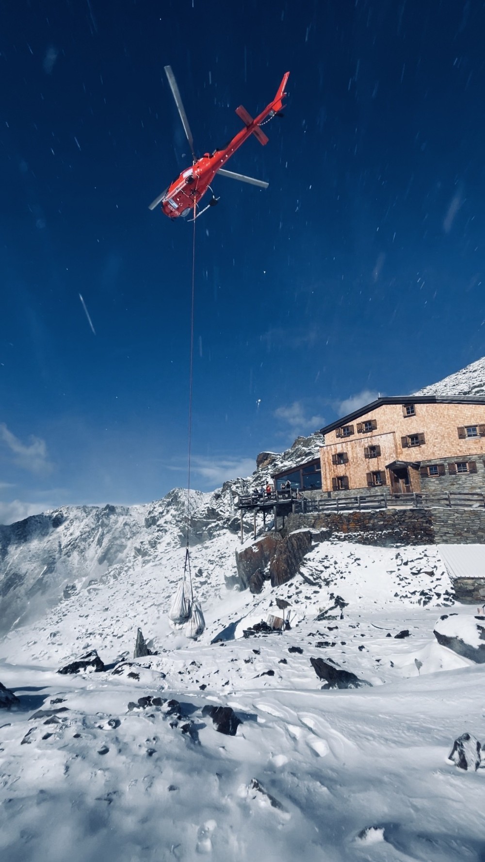 This photo was taken on an aerial working job in Val Senales in South Tyrol. After the first snow in the mountains the crew had to bring down some stuff from the hut.